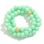 Set of Three Pearlescent Beaded Stretch Bracelets With Dimpled Gold Bead Accent

- Approximately 2.5" D