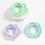 Set of Three Pearlescent Beaded Stretch Bracelets With Dimpled Gold Bead Accent

- Approximately 2.5" D