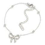 Metal Tone Saturn Chain Link Bracelet Featuring Bow Station

- Approximately 3." D
- Extender 2" L