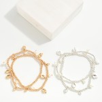 Set of Two Metal Tone Beaded Stretch Bracelets With Pearl and Dimpled Metal Tone Charms

- Approximately 2.5" D