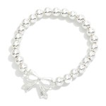 Metal Tone Beaded Stretch Bracelets With Bow Charm

- Approximately 2.5" D