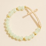 Faceted Bead Beaded Stretch Bracelet Featuring Hammered Metal East West Cross

- Approximately 2.5" D