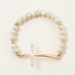 Faceted Bead Beaded Stretch Bracelet Featuring Hammered Metal East West Cross

- Approximately 2.5" D