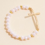 Faceted Bead Beaded Stretch Bracelet Featuring Hammered Metal East West Cross

- Approximately 2.5" D