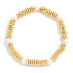 Metal Tone Ridded Disc Stretch Bracelet Featuring Peal Stations

- Approximately 2.5" D  