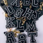 Wholesale black initial pillow keychain bag charm rhinestone details tassel acce