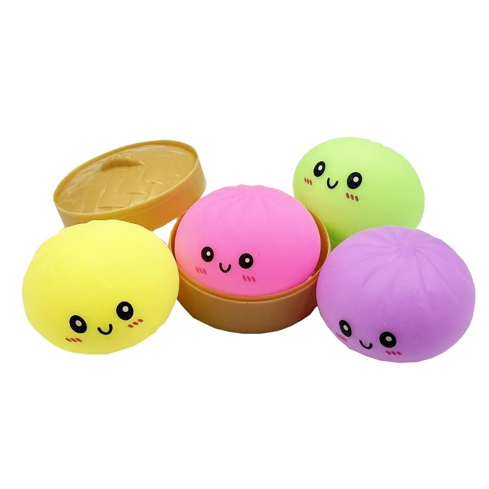 Dumpling Squishy Toy Cute novelty squishy toy designed as a smiling dumpling in a bamboo-style steamer. - Ages 3+ - Approximately 5.5" L view 4