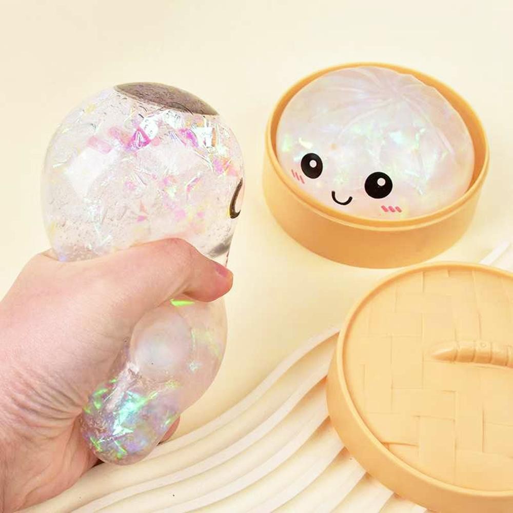 Dumpling Squishy Toy Cute novelty squishy toy designed as a smiling dumpling in a bamboo-style steamer. Perfect for gifts, impulse buys, and food-themed novelty displays. - Ages 3+ - Approximately 3" L view 4
