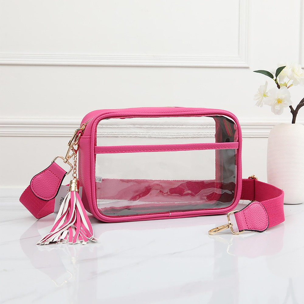Clear PU Cross Body Bag With Leather Walls and Trim Featuring Detachable Leather Tassel - Zip Closure - One Outer Open Pocket - Detachable Canvas Strap - Approximately 6.5" T x 10" L x 2.5" W - Strap Drop 15" - 24" L view 2