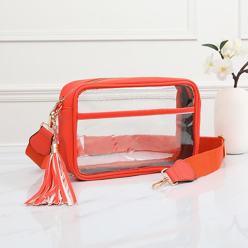 Clear PU Cross Body Bag With Leather Walls and Trim Featuring Detachable Leather Tassel - Zip Closure - One Outer Open Pocket - Detachable Canvas Strap - Approximately 6.5" T x 10" L x 2.5" W - Strap Drop 15" - 24" L view 2