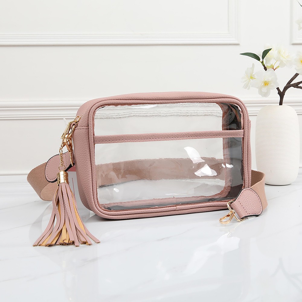 Clear PU Cross Body Bag With Leather Walls and Trim Featuring Detachable Leather Tassel - Zip Closure - One Outer Open Pocket - Detachable Canvas Strap - Approximately 6.5" T x 10" L x 2.5" W - Strap Drop 15" - 24" L view 2