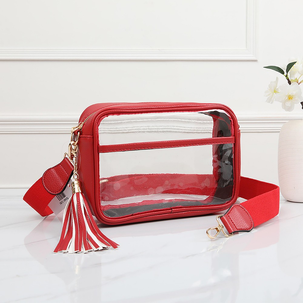 Clear PU Cross Body Bag With Leather Walls and Trim Featuring Detachable Leather Tassel - Zip Closure - One Outer Open Pocket - Detachable Canvas Strap - Approximately 6.5" T x 10" L x 2.5" W - Strap Drop 15" - 24" L view 2