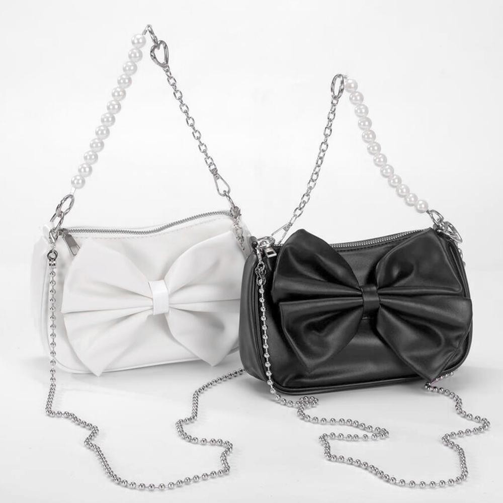 Vegan Leather Bow Cross Body Bag - Full Zipper Closure - Lined Interior With Zipper Pocket - Removable Ball Chain Strap (22"L) - Removable Pearl/Chain Clutch Strap - Approximately 8.5"W X 5.5"T X 2.5"D view 4